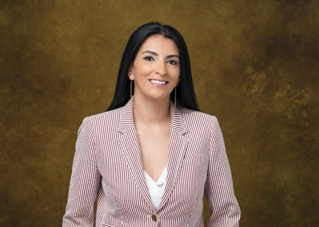 smiling lady in a candy cane pin stripe blazer