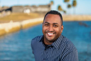 Business professional looking at camera for headshots adjacent to the Castillo San Marcos.