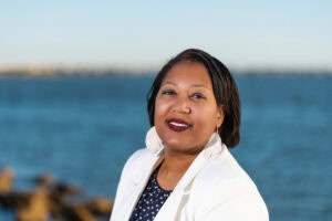 Professional looking at camera for an outdoor professional headshot in front of the bay 