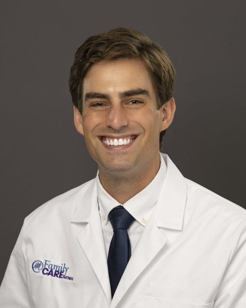 headshot of a smiling man