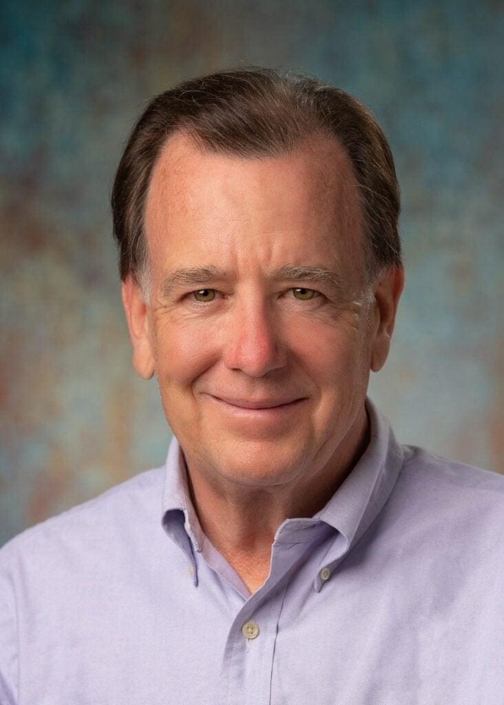 businessman smiling in casual attire for a studio headshot