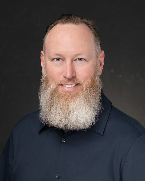 Executive smiling at camera for group professional headshots
